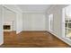 A beautiful room with hardwood floors, a decorative fireplace, and natural light beaming from large windows at 2873 Hilton Nw Cir, Kennesaw, GA 30152