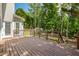 Expansive wooden deck with railings, offering a great view of the lush backyard and mature trees at 2873 Hilton Nw Cir, Kennesaw, GA 30152