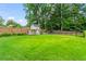 A spacious backyard featuring a lush lawn, a fence for privacy, and a refreshing pool at 2922 Parkridge Ne Dr, Brookhaven, GA 30319