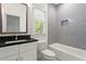 Bathroom features a vanity with a black countertop and a tub with tiled walls at 2922 Parkridge Ne Dr, Brookhaven, GA 30319