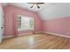 Bedroom featuring hardwood floors, a large window, and light pink painted walls at 2922 Parkridge Ne Dr, Brookhaven, GA 30319