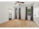 Bedroom with hardwood floors, ceiling fan, and natural light from two windows with curtains at 2922 Parkridge Ne Dr, Brookhaven, GA 30319