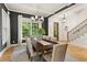 Dining room with dark accent wall, a chandelier, large windows, and a wooden table set for Gathering meals at 2922 Parkridge Ne Dr, Brookhaven, GA 30319