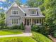 Charming craftsman home featuring a covered front porch, gray siding, manicured landscaping, and a welcoming facade at 2922 Parkridge Ne Dr, Brookhaven, GA 30319