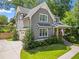 Angle exterior view showcases the home's gray siding, white trim, attached garage, and landscaped front yard at 2922 Parkridge Ne Dr, Brookhaven, GA 30319