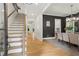 Bright foyer with hardwood floors, staircase, and dining room with dark accent wall, offering a stylish welcome at 2922 Parkridge Ne Dr, Brookhaven, GA 30319