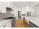 Bright kitchen with stainless steel appliances, white cabinets, and hardwood floors at 2922 Parkridge Ne Dr, Brookhaven, GA 30319