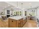 Open concept kitchen with island, white countertops, and adjacent breakfast nook and living room at 2922 Parkridge Ne Dr, Brookhaven, GA 30319