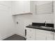 Laundry room featuring cabinetry, sink, drying rack, and washer/dryer hookups at 2922 Parkridge Ne Dr, Brookhaven, GA 30319