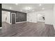 Open-concept living room with hardwood floors, recessed lighting, and a decorative accent wall in a contemporary style at 2922 Parkridge Ne Dr, Brookhaven, GA 30319