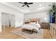 Main bedroom with hardwood floors, paneled accent wall, and tray ceiling at 2922 Parkridge Ne Dr, Brookhaven, GA 30319