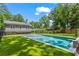 Backyard oasis with in-ground pool and lush green lawn with neighborhood trees in the background at 2922 Parkridge Ne Dr, Brookhaven, GA 30319
