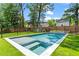 Backyard with in-ground swimming pool and spa surrounded by well-manicured lawn and privacy fence at 2922 Parkridge Ne Dr, Brookhaven, GA 30319