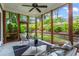 Screened-in porch filled with natural light, featuring modern outdoor furniture and serene views of the landscaped backyard at 2922 Parkridge Ne Dr, Brookhaven, GA 30319