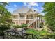Picture of a multi-level backyard with firepit seating and a lush, wooded backdrop at 3088 Hidden Falls Dr, Buford, GA 30519
