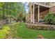Gorgeous backyard with stone landscaping, a fire pit seating area, and mature trees at 3088 Hidden Falls Dr, Buford, GA 30519