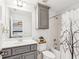 Cozy bathroom featuring gray vanity, framed mirror, tiled shower over tub, and decorative shower curtain at 3088 Hidden Falls Dr, Buford, GA 30519