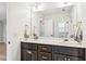 Well-lit bathroom with double vanity, framed mirror, shaker cabinets, and decorative hardware at 3088 Hidden Falls Dr, Buford, GA 30519