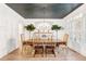 Elegant dining room with gray ceiling, wainscoting, hardwood floors, and stylish light fixture at 3088 Hidden Falls Dr, Buford, GA 30519