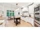 Bright kitchen featuring custom cabinets, a center island, and stainless steel appliances at 3088 Hidden Falls Dr, Buford, GA 30519