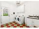 Laundry room with stainless steel appliances and bright checkered floor at 3088 Hidden Falls Dr, Buford, GA 30519