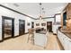 Spacious living room with a modern island, barstool seating, and hardwood flooring throughout the room at 3088 Hidden Falls Dr, Buford, GA 30519