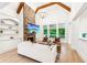 Bright living room with vaulted ceilings, stone fireplace, and built-in bookshelves at 3088 Hidden Falls Dr, Buford, GA 30519