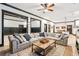 Open-concept living room features a sectional sofa, modern decor, and flows into the dining and kitchen areas at 3088 Hidden Falls Dr, Buford, GA 30519