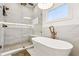 Bright bathroom featuring modern fixtures, soaking tub and walk in shower at 3088 Hidden Falls Dr, Buford, GA 30519