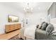 Cozy main bedroom featuring hardwood floors, TV, and ensuite bath at 3088 Hidden Falls Dr, Buford, GA 30519