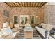 Inviting outdoor patio with brick walls, comfortable seating, and a cozy ambiance for relaxing and entertaining at 3088 Hidden Falls Dr, Buford, GA 30519