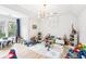 Spacious playroom featuring light hardwood floors, bright natural light, and an assortment of toys at 3088 Hidden Falls Dr, Buford, GA 30519