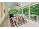 Covered porch with outdoor seating and wooded views at 3088 Hidden Falls Dr, Buford, GA 30519