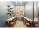 Charming wine room with seating, wine racks, a stone wall, and a beverage cooler for entertaining guests at 3088 Hidden Falls Dr, Buford, GA 30519