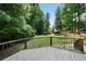 Back deck overlooking a large, grassy backyard surrounded by mature trees at 4544 Cavallon Nw Way, Acworth, GA 30101