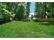 Expansive backyard featuring lush green lawn, mature trees, and a peaceful, private setting at 4544 Cavallon Nw Way, Acworth, GA 30101