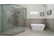 Contemporary bathroom featuring a frameless glass shower, a freestanding tub, and modern fixtures at 4544 Cavallon Nw Way, Acworth, GA 30101