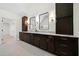 Bathroom with granite countertops, dark cabinets, tile floor, and and sink at 4544 Cavallon Nw Way, Acworth, GA 30101