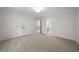 An empty bedroom with carpeted floors, white walls, and a double door closet at 4544 Cavallon Nw Way, Acworth, GA 30101