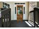 Covered front porch with a wood door, railings, and inviting curb appeal at 4544 Cavallon Nw Way, Acworth, GA 30101
