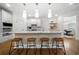 Open kitchen with island, modern lighting, and wood floors, ideal for cooking and entertaining at 4544 Cavallon Nw Way, Acworth, GA 30101