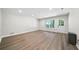 Spacious living room featuring wood flooring, recessed lighting, and natural light from the window and door at 4544 Cavallon Nw Way, Acworth, GA 30101