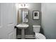 Charming powder room featuring a pedestal sink, modern toilet, decorative mirror and gray paint at 4544 Cavallon Nw Way, Acworth, GA 30101