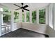 Cozy sunroom with wood floors, screened windows, and views of the backyard at 4544 Cavallon Nw Way, Acworth, GA 30101