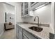 Elegant wet bar showcasing granite counters, stylish cabinetry, and a convenient sink for entertaining guests at 4544 Cavallon Nw Way, Acworth, GA 30101