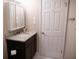 Bathroom featuring a single sink, dark vanity, granite countertop, and white door at 37 La Rue Nw Pl, Atlanta, GA 30327