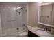 Bathroom with a tub, shower with glass door, granite countertop and dark vanity at 37 La Rue Nw Pl, Atlanta, GA 30327