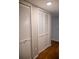 Hallway linen closets featuring louvered doors and hardwood flooring at 37 La Rue Nw Pl, Atlanta, GA 30327
