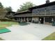 Exterior of clubhouse with a stone facade, covered porch, green space and golf putting practice area at 37 La Rue Nw Pl, Atlanta, GA 30327