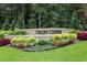Landscaped Cross Creek community entrance sign with manicured plants and lush greenery at 37 La Rue Nw Pl, Atlanta, GA 30327